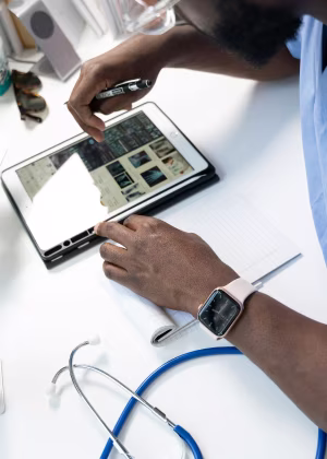 Healthcare professional interacting with a tablet.
